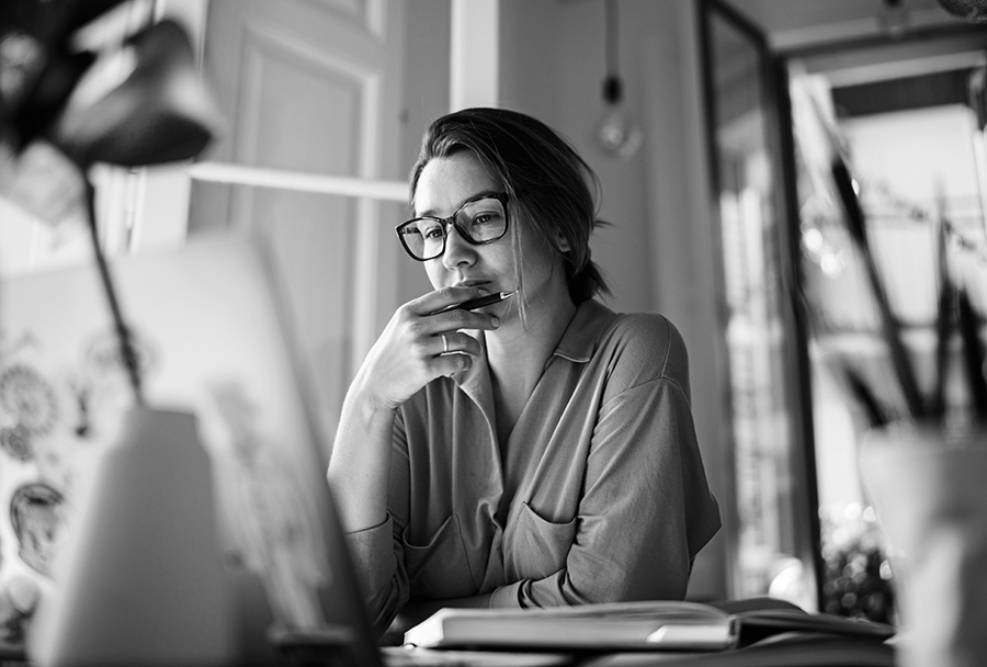 business owner at computer thinking