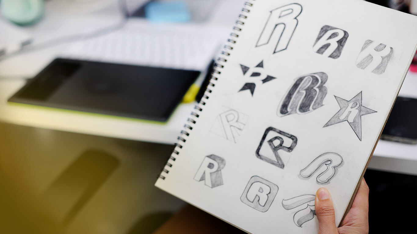 notebook with logo drafts